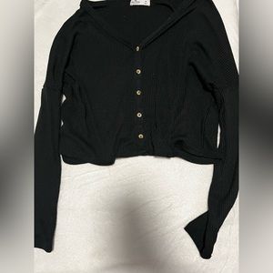 It runs big so if you’re a large it would also fit. Cotton.